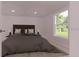 Serene bedroom featuring neutral tones, a plush bed, and a bright window view at 17445 Sw 25Th Ct, Ocala, FL 34473
