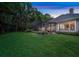 Spacious backyard featuring lush greenery and a screened-in porch for outdoor enjoyment and privacy at 1810 Oakbrook Dr, Longwood, FL 32779