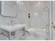 Elegant bathroom with white marble walls, a stand sink, toilet, and a tub with shower at 1810 Oakbrook Dr, Longwood, FL 32779