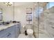 Modern bathroom with marble walk-in shower, granite countertop, and gray vanity at 1810 Oakbrook Dr, Longwood, FL 32779