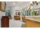 Luxurious bathroom boasts dual vanities with marble countertops and decorative lighting at 1810 Oakbrook Dr, Longwood, FL 32779
