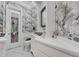Stylish black and white bathroom with modern fixtures, vanity, and statement wallpaper at 1810 Oakbrook Dr, Longwood, FL 32779