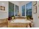Relaxing tub in a spa-like bathroom setting, complete with tile surround and natural light at 1810 Oakbrook Dr, Longwood, FL 32779