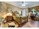 Bedroom featuring a decorative tropical bed set and a desk near the window, with hardwood floors at 1810 Oakbrook Dr, Longwood, FL 32779