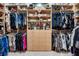 Well-organized walk-in closet with hanging rods, shelving, and central drawers for maximum storage at 1810 Oakbrook Dr, Longwood, FL 32779