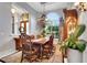 Charming dining room with elegant decor, including a chandelier, decorative rug, and custom draperies at 1810 Oakbrook Dr, Longwood, FL 32779