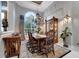 Charming dining room with elegant decor, including a chandelier, decorative rug, and custom draperies at 1810 Oakbrook Dr, Longwood, FL 32779