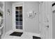 Welcoming entryway featuring a decorative mirror and tile flooring for a clean and stylish home entrance at 1810 Oakbrook Dr, Longwood, FL 32779