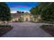 Stately home boasts lush landscaping and a circular brick driveway leading to its grand entrance at 1810 Oakbrook Dr, Longwood, FL 32779