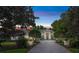 Elegant home featuring manicured greenery framing a symmetrical facade with a brick driveway at 1810 Oakbrook Dr, Longwood, FL 32779