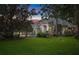 Charming single-story home with mature trees, lush green lawn, and neutral-toned exterior paint at 1810 Oakbrook Dr, Longwood, FL 32779