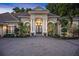 Attractive home featuring a paved driveway leading to a welcoming entrance with an arched entryway at 1810 Oakbrook Dr, Longwood, FL 32779