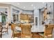 Elegant kitchen showcases a large island, wood cabinets, stainless appliances and eat-in table at 1810 Oakbrook Dr, Longwood, FL 32779