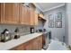 Well-organized laundry room features ample cabinet space, quartz countertops, and modern washer/dryer at 1810 Oakbrook Dr, Longwood, FL 32779