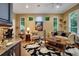 Warm living room with dark wood floors, a comfortable seating area, and natural lighting at 1810 Oakbrook Dr, Longwood, FL 32779