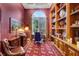 Elegant office with custom built-ins, a large arched window, and sophisticated decor at 1810 Oakbrook Dr, Longwood, FL 32779
