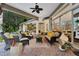 Spacious covered patio with comfortable seating, ceiling fans, and views of pool at 1810 Oakbrook Dr, Longwood, FL 32779
