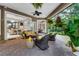 Inviting covered patio with brick flooring, wicker furniture and tranquil views of lush greenery at 1810 Oakbrook Dr, Longwood, FL 32779