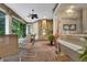 Covered patio features brick floors, outdoor kitchen with grill, and lush greenery at 1810 Oakbrook Dr, Longwood, FL 32779