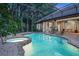 Beautiful pool and spa area enclosed with screened lanai and featuring lush landscaping at 1810 Oakbrook Dr, Longwood, FL 32779
