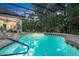 Screened-in pool with spa, covered patio, and outdoor entertainment space at 1810 Oakbrook Dr, Longwood, FL 32779