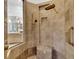Tiled shower features built-in bench, rainfall shower head and hand held at 1810 Oakbrook Dr, Longwood, FL 32779