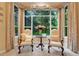 Cozy sitting area with large window, seating for two, and lush outdoor view at 1810 Oakbrook Dr, Longwood, FL 32779
