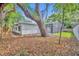 Backyard featuring mature shade trees and a glimpse of the screened-in pool at 1850 Shawnee Trl, Maitland, FL 32751