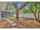 Leafy backyard featuring a screened-in pool and walkway at 1850 Shawnee Trl, Maitland, FL 32751