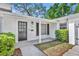 Inviting front entrance with a modern door, stylish lighting, and well-manicured landscaping at 1850 Shawnee Trl, Maitland, FL 32751
