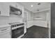 Well-lit kitchen featuring modern appliances, clean finishes, and an adjacent dining area with a stylish light fixture at 1850 Shawnee Trl, Maitland, FL 32751