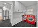 Well-equipped laundry room with red washer/dryer set and ample cabinet space at 1850 Shawnee Trl, Maitland, FL 32751
