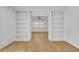 Inviting living room with light hardwood floors and large built-in shelving perfect for entertaining at 1850 Shawnee Trl, Maitland, FL 32751