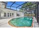 Gorgeous screened-in pool with lounge area, ceiling fan, and multiple french doors at 1850 Shawnee Trl, Maitland, FL 32751