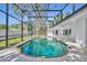 Relaxing screened-in pool with metal ladder, lush backyard, and white patio at 1850 Shawnee Trl, Maitland, FL 32751