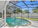 Inviting screened-in pool with turquoise water, brick trim, and white patio at 1850 Shawnee Trl, Maitland, FL 32751