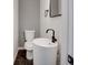 Compact powder room with a pedestal sink and modern fixtures at 1850 Shawnee Trl, Maitland, FL 32751