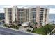 Aerial view of a modern condo building with stunning ocean views and a circular driveway entrance at 1925 S Atlantic Ave # 411, Daytona Beach, FL 32118