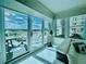 Bright sunroom featuring wall to wall sliding glass doors opening up to a balcony overlooking the city at 1925 S Atlantic Ave # 411, Daytona Beach, FL 32118