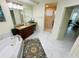 Bright bathroom featuring dual sinks, a jacuzzi tub, and glass shower at 1925 S Atlantic Ave # 411, Daytona Beach, FL 32118