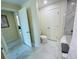 Bathroom featuring a toilet, bathtub, and tile flooring in a home's well-lit interior at 1925 S Atlantic Ave # 411, Daytona Beach, FL 32118
