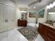 Bright bathroom featuring dual sinks, a jacuzzi tub, and decorative art at 1925 S Atlantic Ave # 411, Daytona Beach, FL 32118