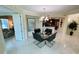 Dining room featuring a modern chandelier, table, chairs, and decor with tile floors at 1925 S Atlantic Ave # 411, Daytona Beach, FL 32118
