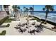 Outdoor fire pit area with Adirondack chairs, palm trees, and ocean views in a beautifully landscaped space at 1925 S Atlantic Ave # 411, Daytona Beach, FL 32118