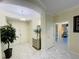 Bright foyer with marble floors, elegant lighting, and a decorative mirrored console table at 1925 S Atlantic Ave # 411, Daytona Beach, FL 32118