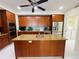 Spacious kitchen featuring an island, wooden cabinets, and stainless steel appliances at 1925 S Atlantic Ave # 411, Daytona Beach, FL 32118