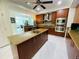 Spacious kitchen featuring an island, wood cabinets, and stainless steel appliances at 1925 S Atlantic Ave # 411, Daytona Beach, FL 32118