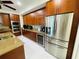 Modern kitchen featuring stainless steel appliances, wine cooler, and wooden cabinetry at 1925 S Atlantic Ave # 411, Daytona Beach, FL 32118