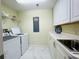 Functional laundry room with modern washer and dryer, ample counter space, and white cabinetry at 1925 S Atlantic Ave # 411, Daytona Beach, FL 32118