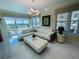 Cozy living room boasts marble floors, modern lighting, white couches, a large window, and stylish decor at 1925 S Atlantic Ave # 411, Daytona Beach, FL 32118